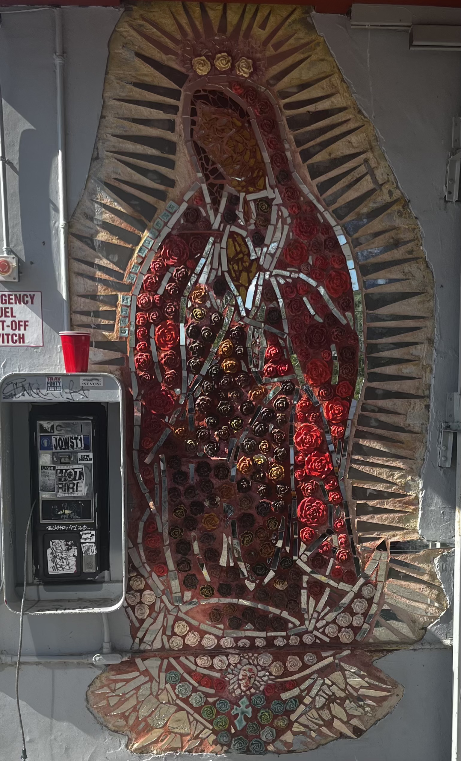 Mary mosaic, roses, payphone, urban street art.