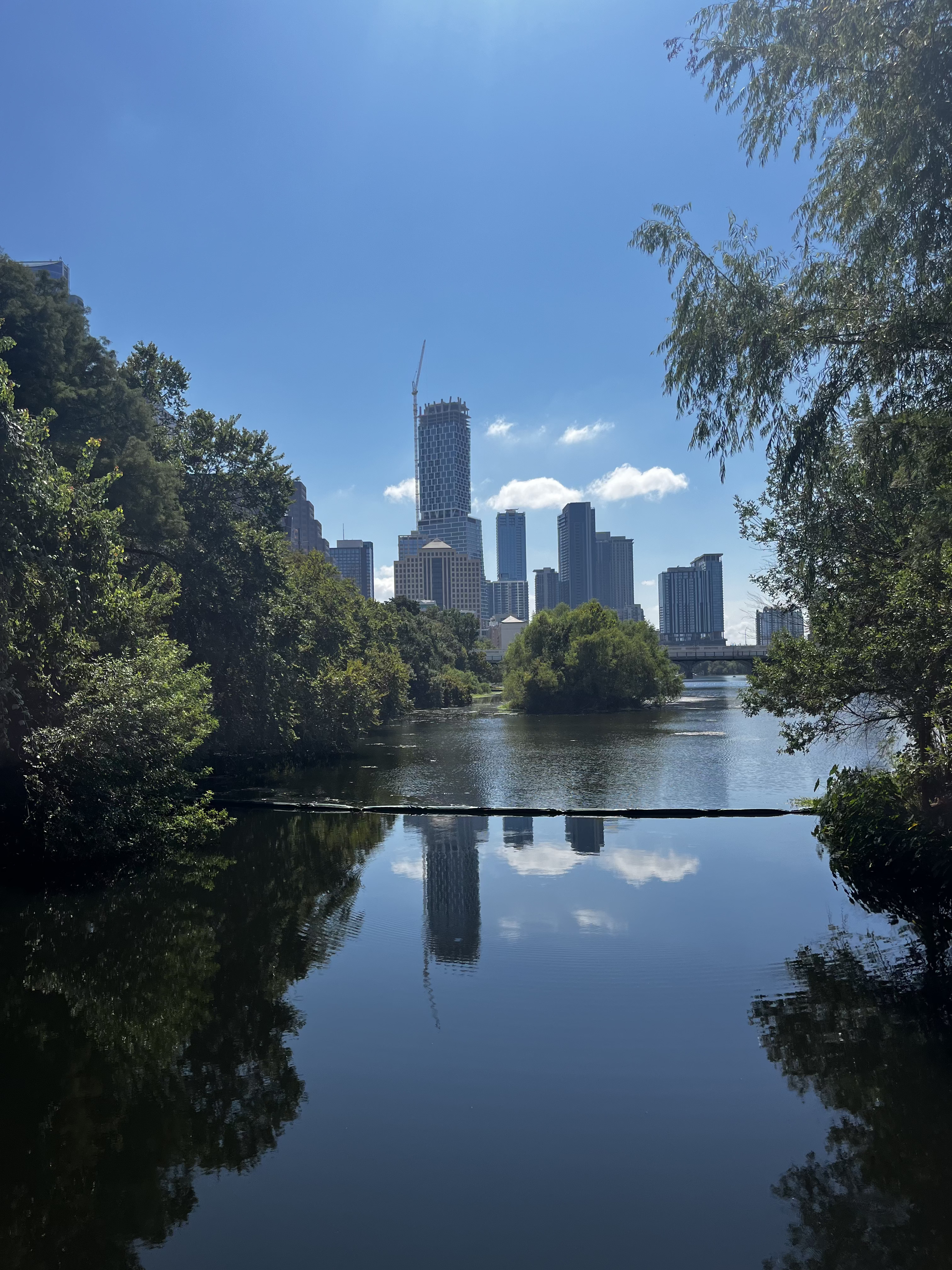 Downtown Austin skyline reflected in the calm Colorado River.