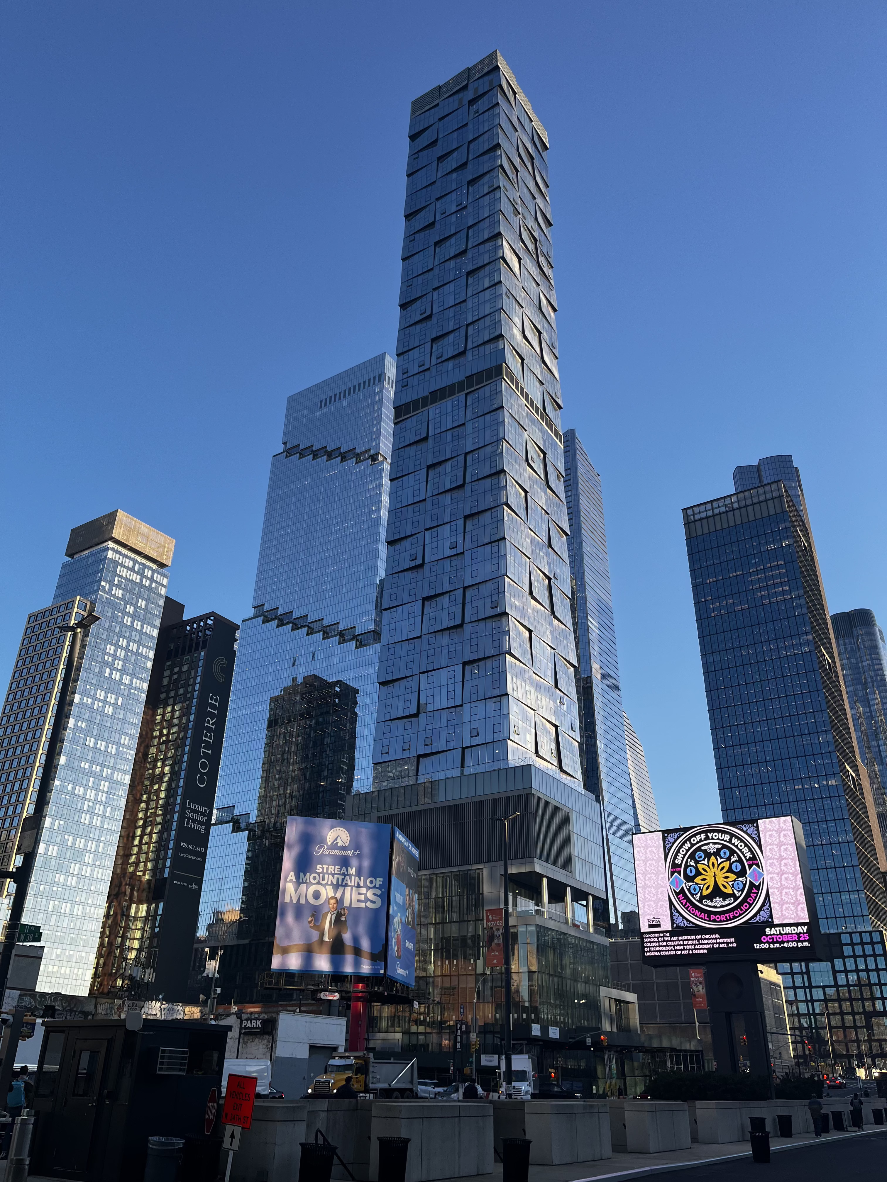 Modern skyscrapers pierce a clear blue sky.