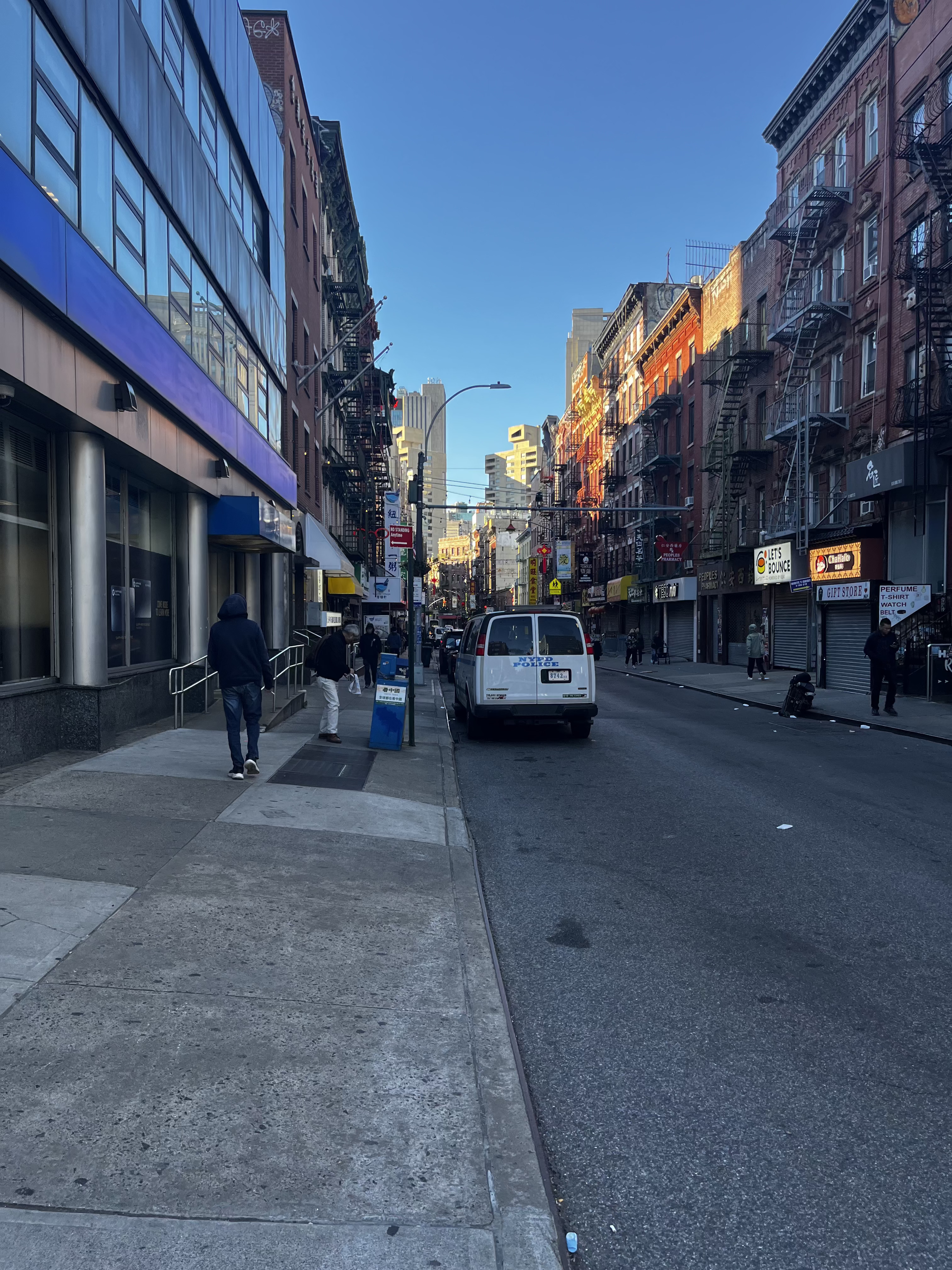 Chinatown street with an NYPD van.