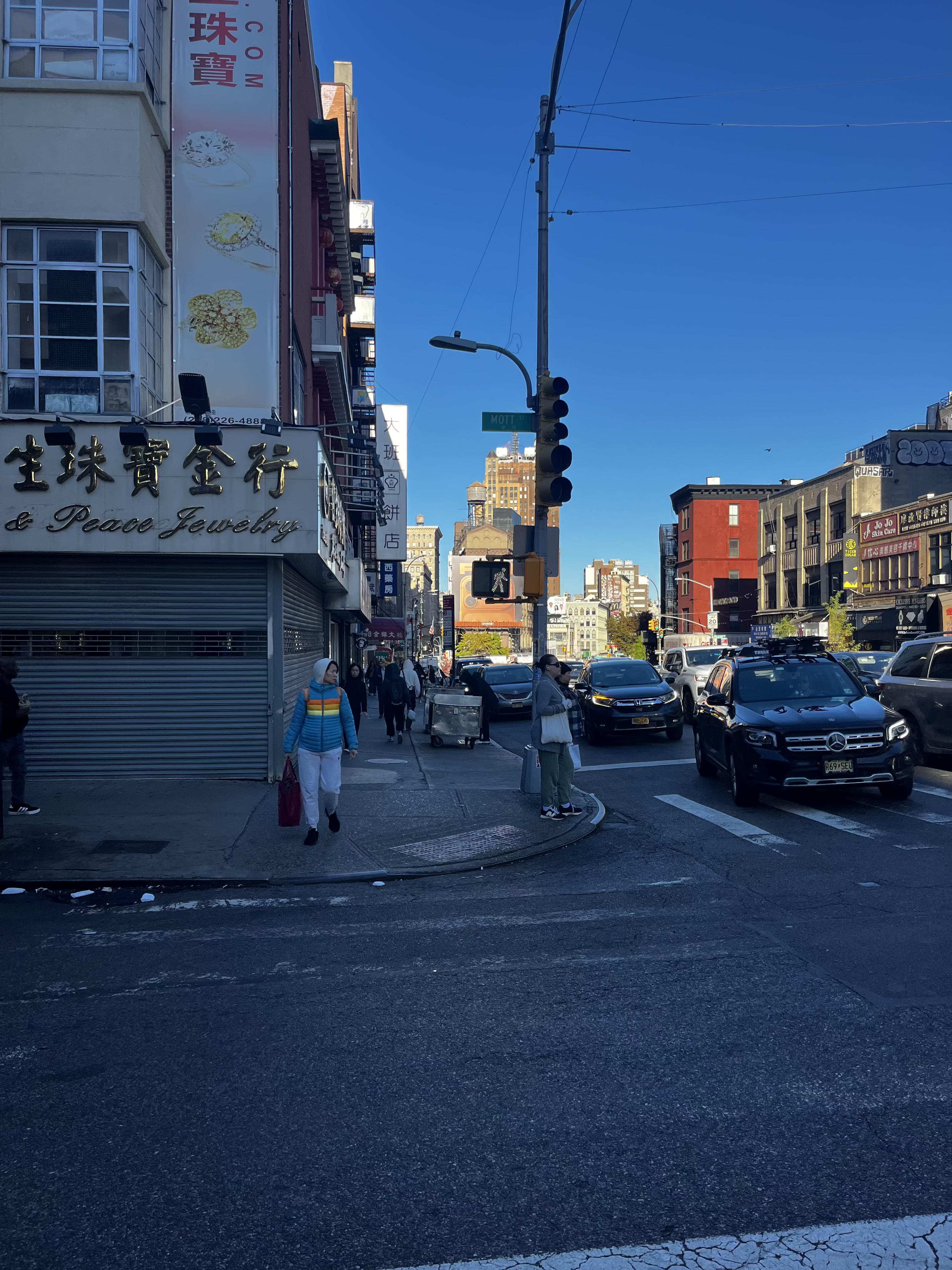 A vibrant Chinatown intersection bustling with life.