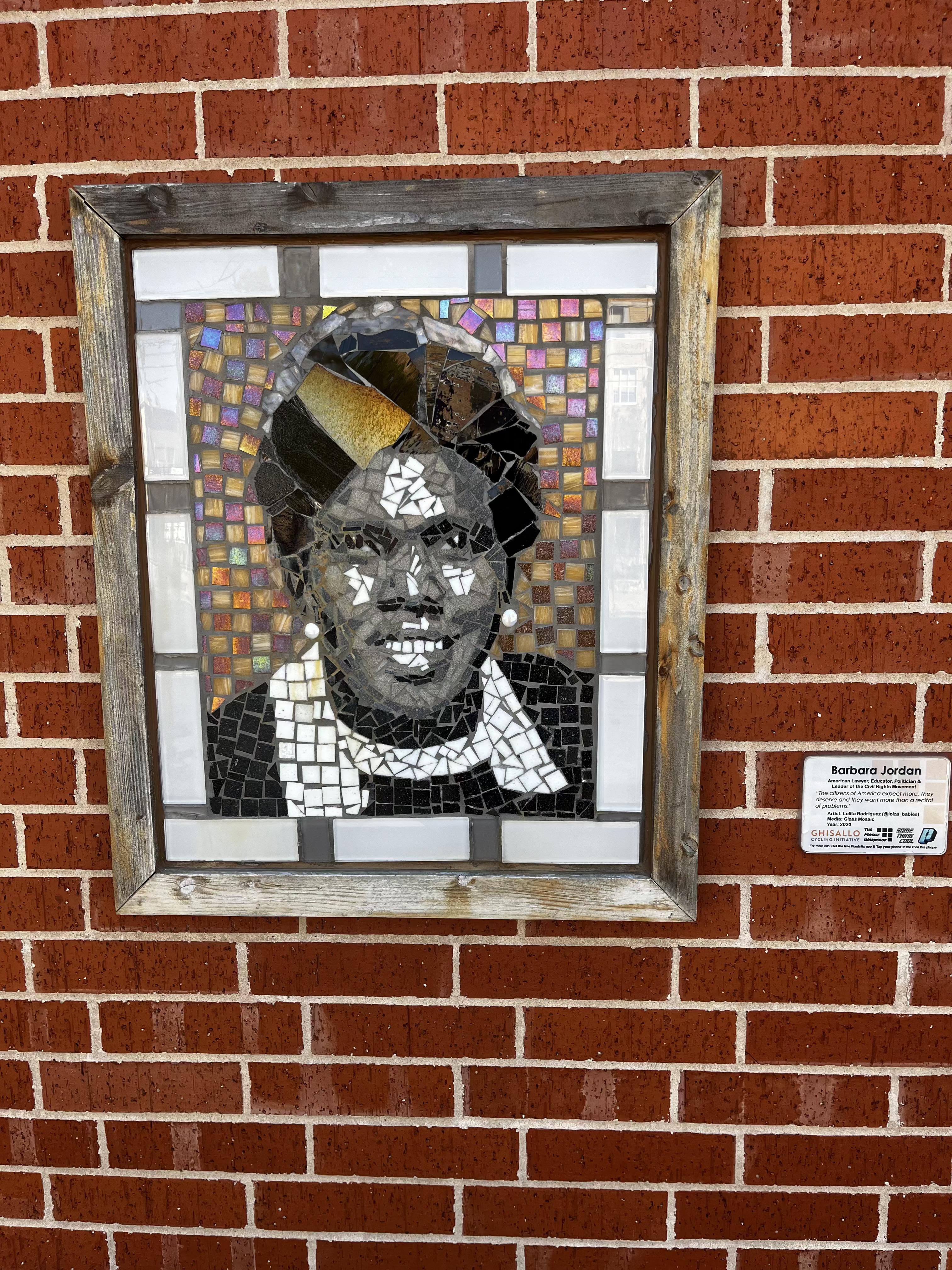 Mosaic portrait of Barbara Jordan on a brick wall.